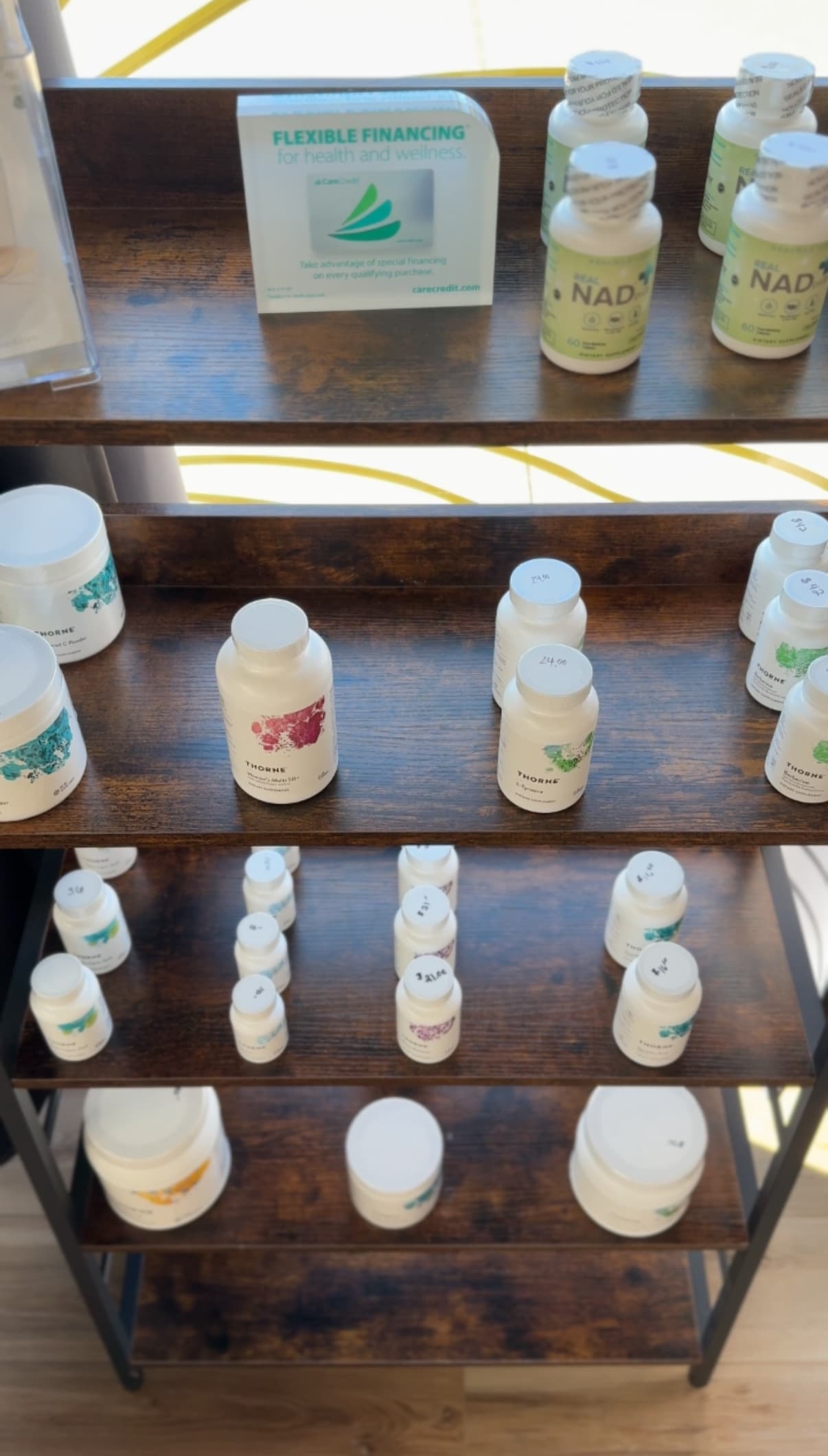Gen 3 supplement bottles arranged on a clinic shelf