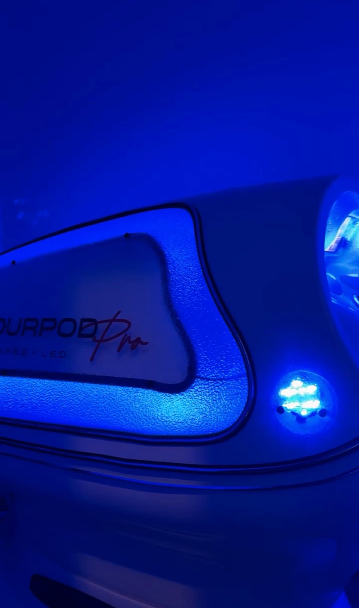 Red light therapy pod glowing blue
